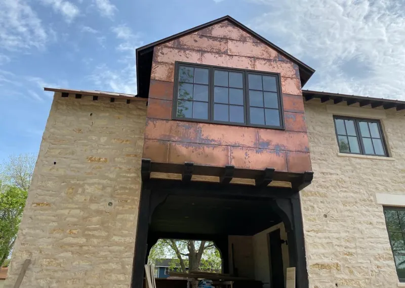 Copper metal panel facade on a stone building for Skylight Installation in Atlantic Beach